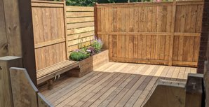 pressure treated deck with gardens and privacy fence